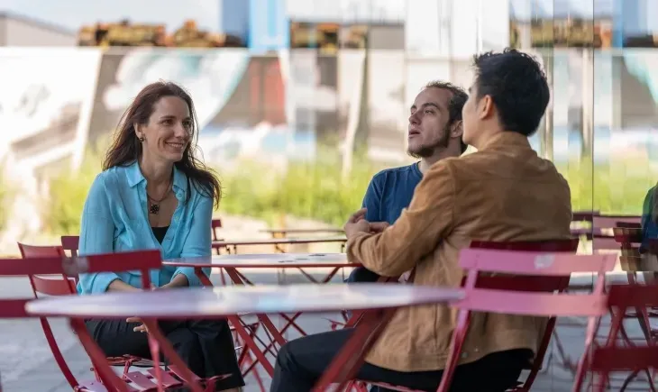 group of students sitting on outdoor table